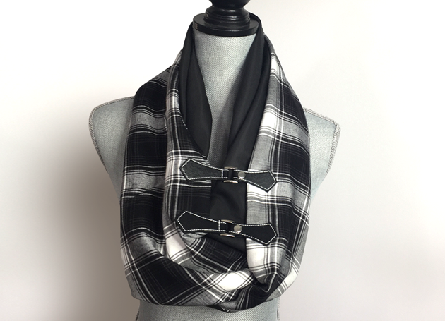 Stay warm in style with a double-sided infinity scarf. This version features faux leather closure detailing plus two different fabrics for added interest.